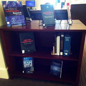 bookshelf containing books on cybersecurity